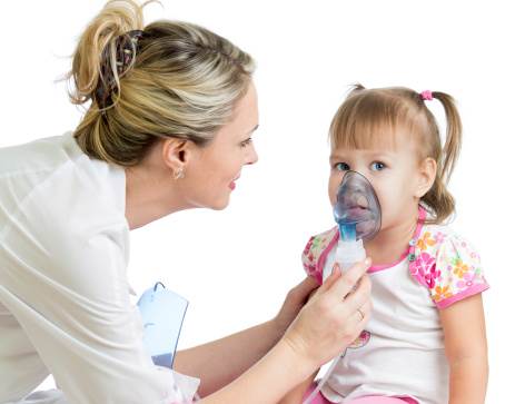 Doctor holding inhaler mask for kid girl breathing